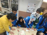 Our students draing henna with the elderly